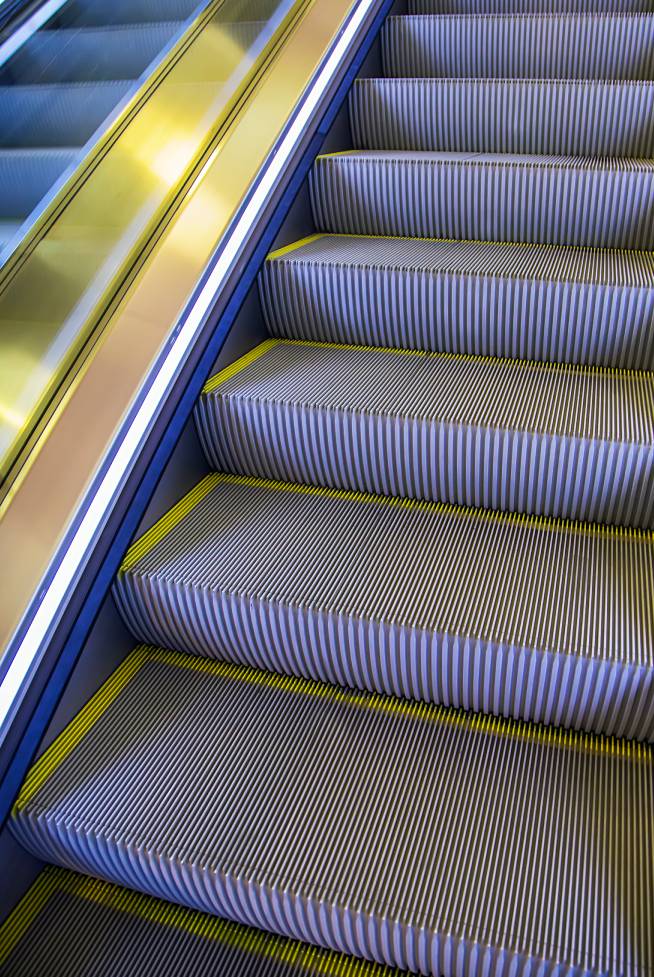 Modern escalator steps with yellow safety edges