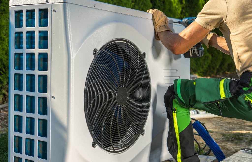 HVAC technician servicing outdoor equipment
